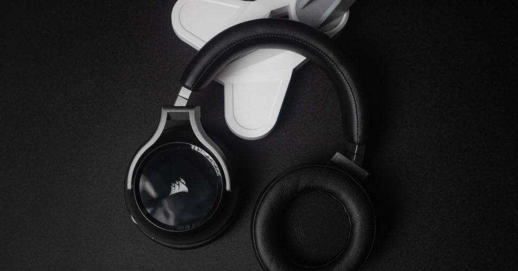 Modern black stereo headphones on a black background, perfect for tech and music themes.