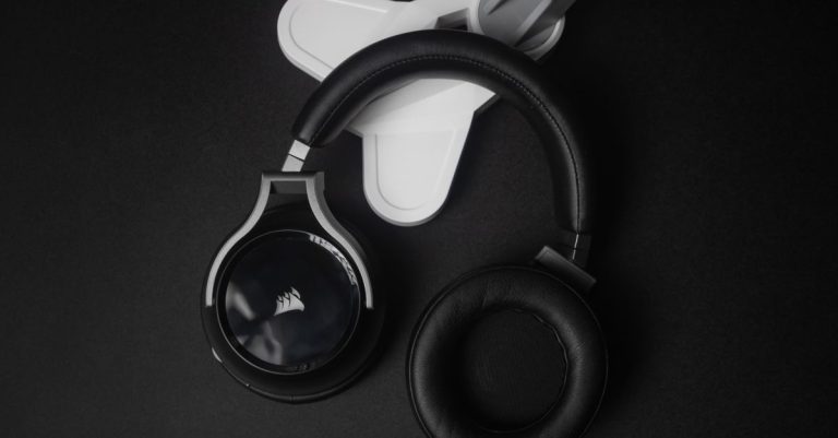 Modern black stereo headphones on a black background, perfect for tech and music themes.