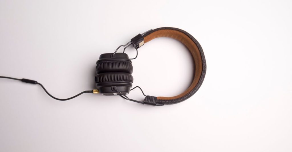 Minimalist image of black over-ear headphones on a white background.