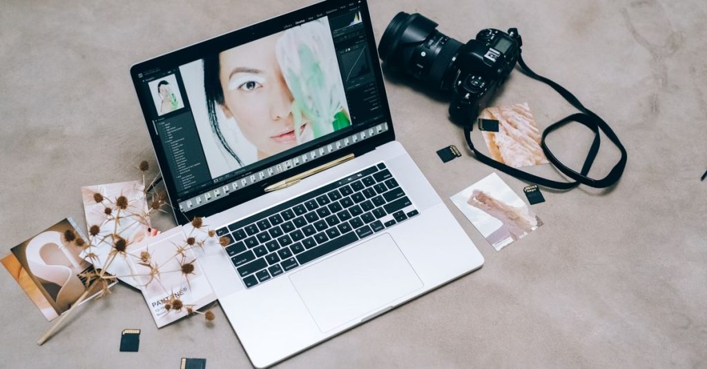 A creative workspace featuring photography equipment and a laptop for digital editing and photo management.