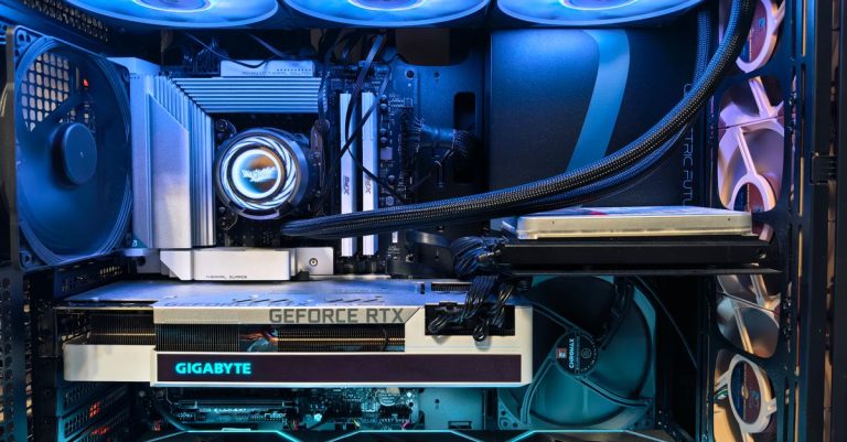 Close-up of an advanced gaming desktop PC with GeForce RTX, liquid cooling, and RGB lighting.