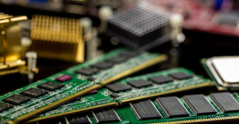 Detailed view of RAM sticks and microprocessors on a motherboard.
