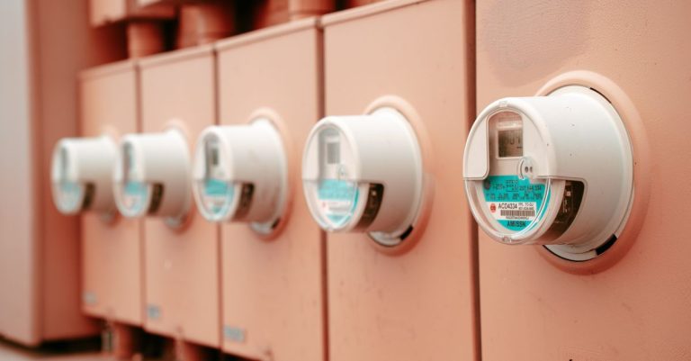 Close-up view of a row of industrial electricity meters for power monitoring and technology.