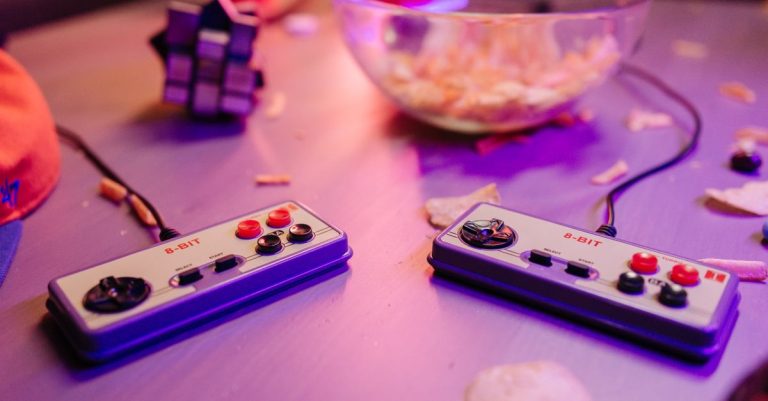 Retro gaming scene featuring classic 8-bit controllers and a relaxed setting with snacks.