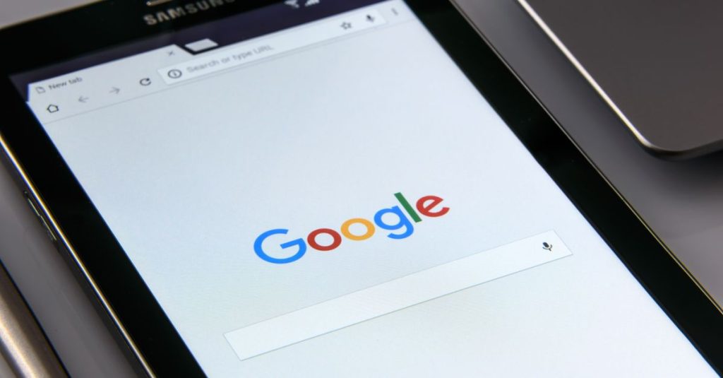 Close-up of a tablet displaying Google's search screen, emphasizing technology and internet browsing.
