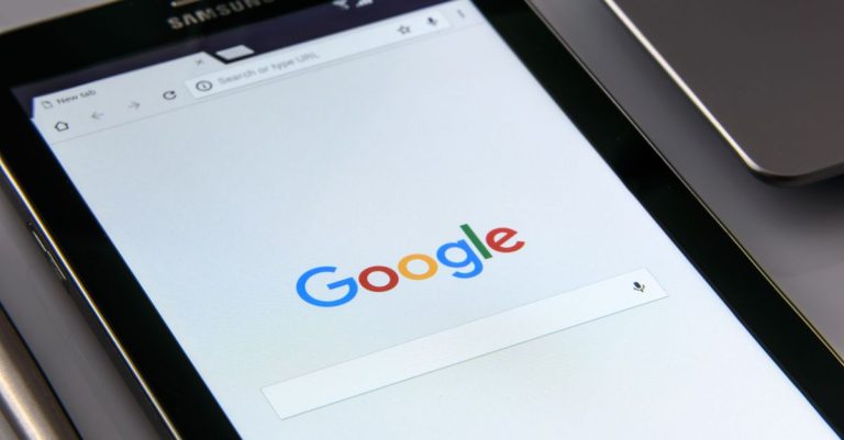 Close-up of a tablet displaying Google's search screen, emphasizing technology and internet browsing.