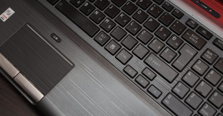 Detailed top view of a laptop keyboard and touchpad, ideal for technology themes.