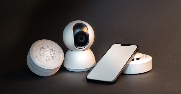 A sleek smartphone with modern smart home devices on a minimalist gray background.