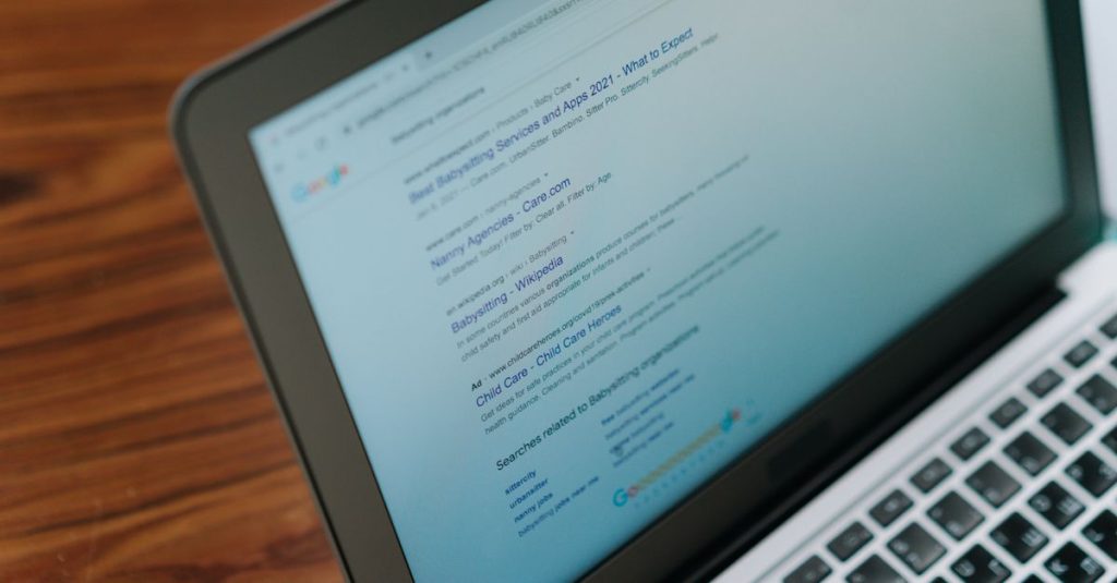 A close-up view of a laptop displaying a search engine page.