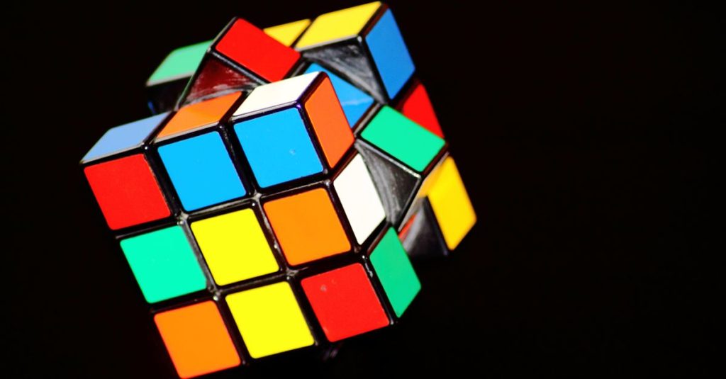 A close-up of a colorful Rubik's Cube puzzle, showcasing concentration and play.