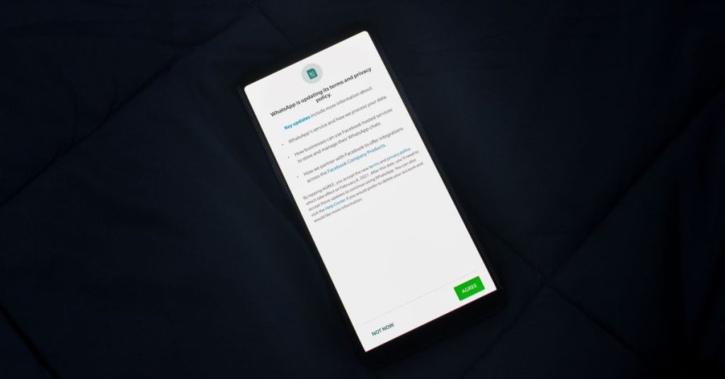 Close-up of smartphone screen showing a privacy policy update agreement.