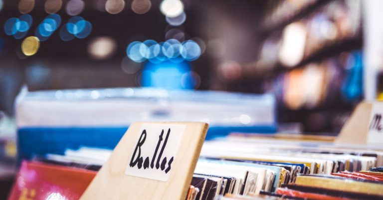 Explore a retro music store with vintage Beatles vinyl records on display.
