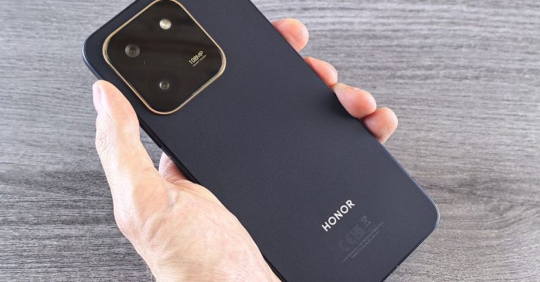 Detailed shot of a person holding a sleek smartphone with a visible camera module.