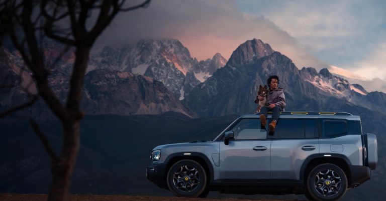 Adventure scene with person and dog on SUV against mountain twilight backdrop.