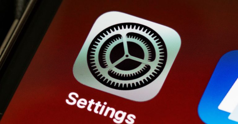 Detailed view of the iPhone screen showing the settings app icon.
