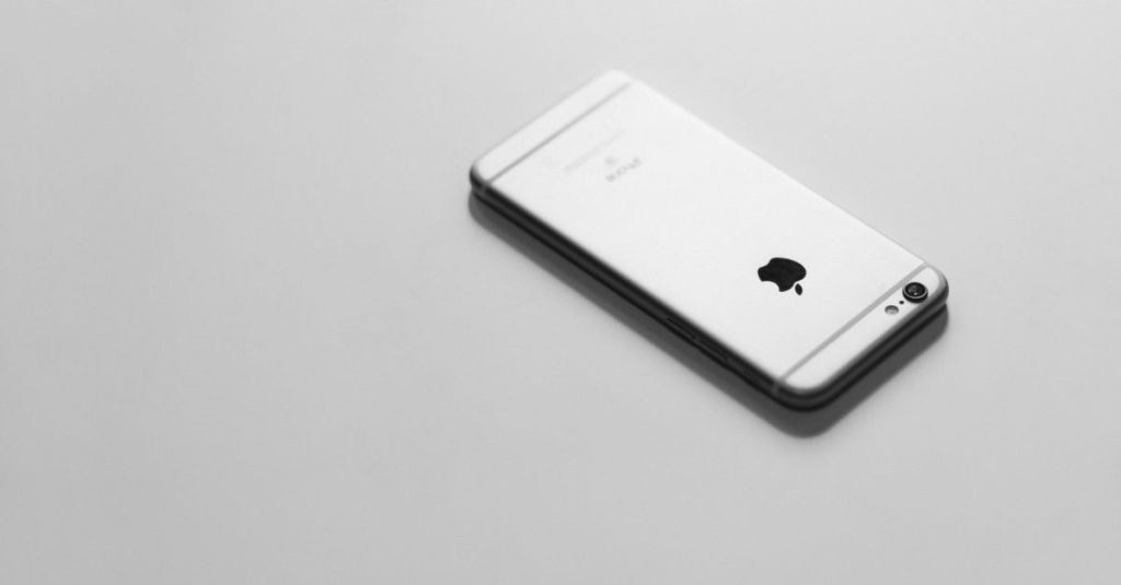 Elegant minimalist image of a smartphone on a white background.