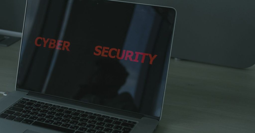 Close-up of a laptop displaying cybersecurity text, emphasizing digital security themes.