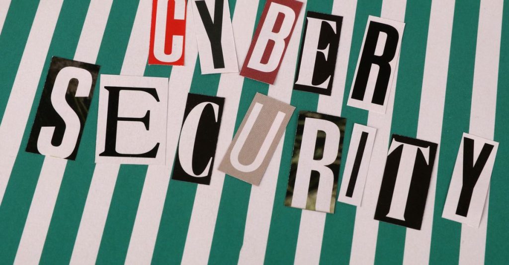Colorful cutout letters spelling 'Cyber Security' on a striped background.
