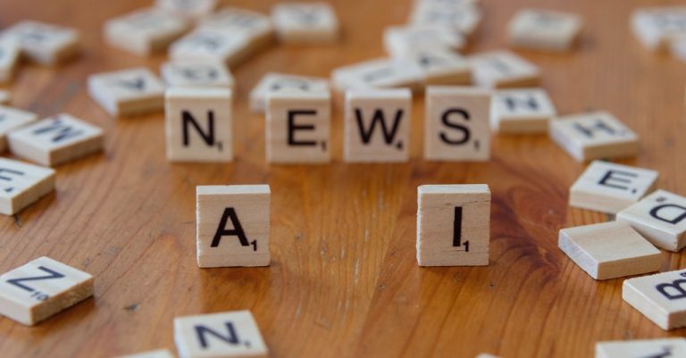 Wooden Scrabble tiles spelling 'AI' and 'NEWS' for a tech concept image.