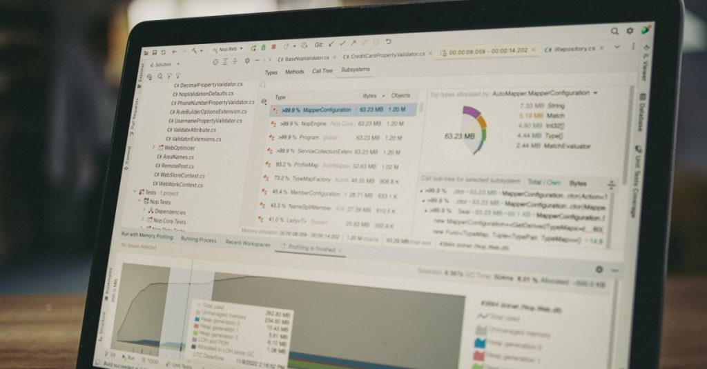 A close-up view of a laptop screen showing a coding and data analysis software interface in an indoor setting.