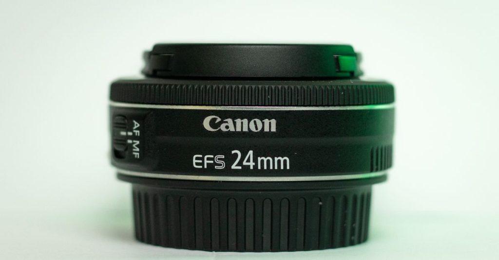 Detailed image showcasing a Canon EF-S 24mm lens with autofocus switches.