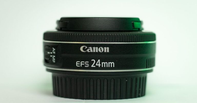 Detailed image showcasing a Canon EF-S 24mm lens with autofocus switches.