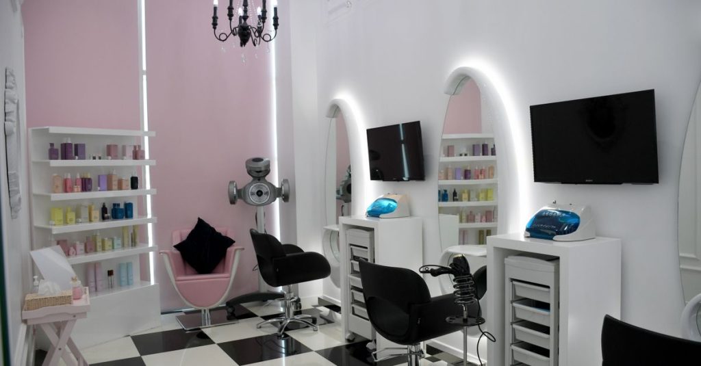 Stylish beauty salon with chic interiors, mirrors, and equipment in Abu Dhabi.