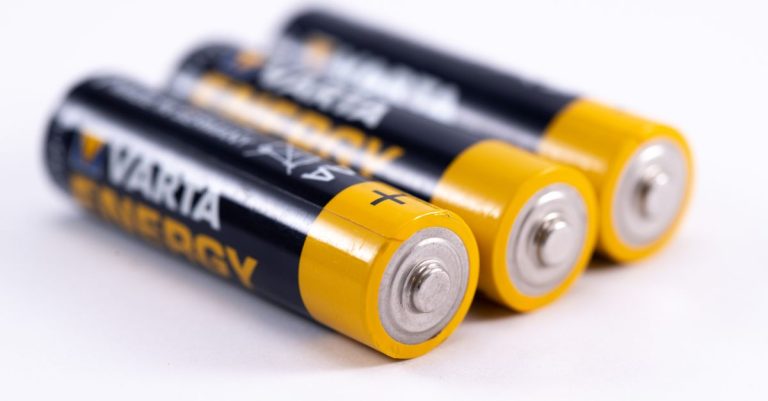 High-quality image showcasing a close-up view of three alkaline batteries on a white surface.