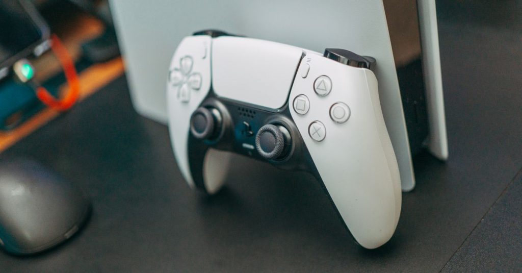 Close-up of a PlayStation 5 controller resting on its console, showcasing modern gaming technology.