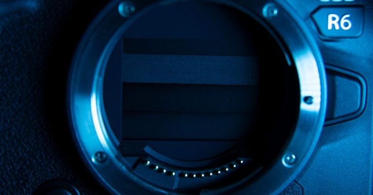 Detailed view of a camera lens mount on a professional camera body.