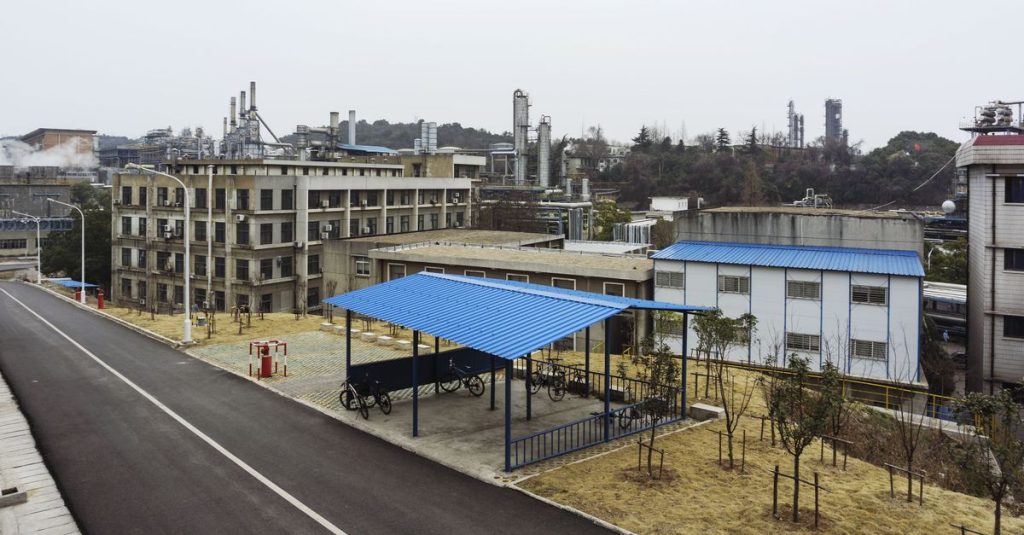 A modern industrial complex with bicycle parking under a blue metal roof.