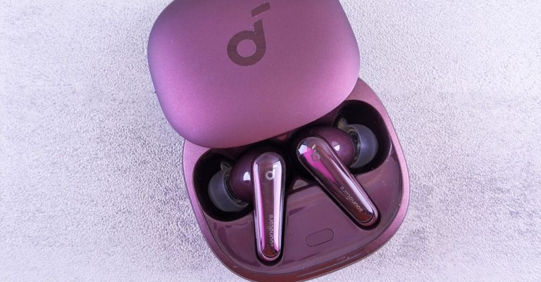 Modern purple earbuds resting in an open case, featuring glossy finish and sleek design.