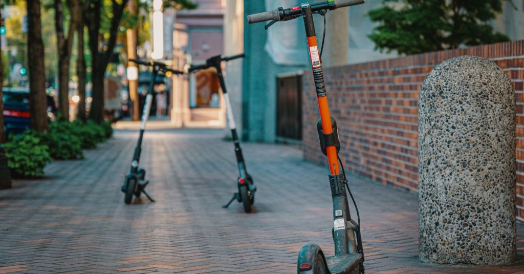 Electric scooters parked on a city sidewalk, embracing urban transportation and modern mobility.