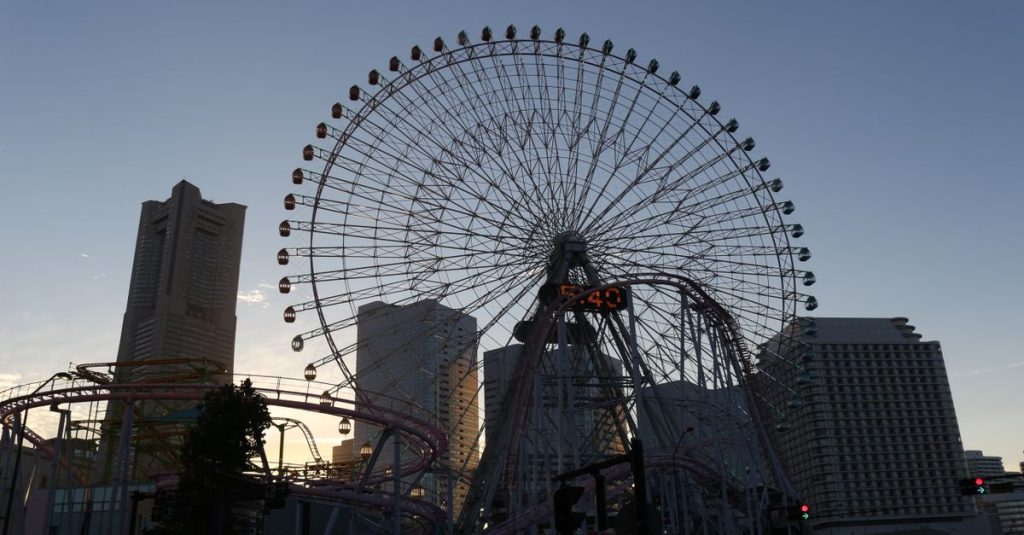 Ferris wheel silhouette and skyline at dusk in Yokohama, Japan.