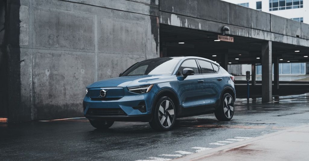 Blue Volvo SUV parked in a modern urban environment showcasing sleek design and urban lifestyle.